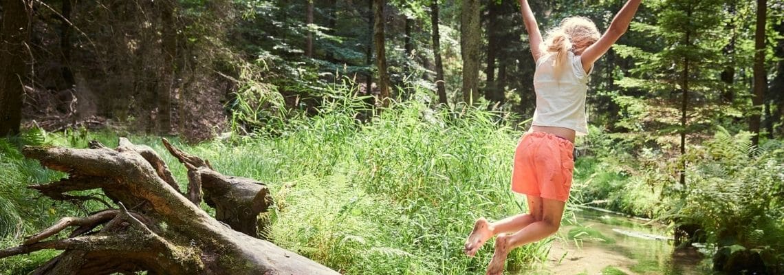 Girl Jumping In Creek. Knows how to free up time.